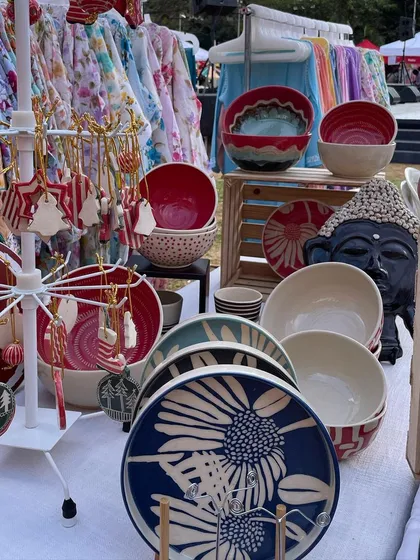 Another view of my market setup, showcasing my Dutch Iris plates and a variety of Christmas ornaments. It’s a vibrant and colorful representation of my brand.