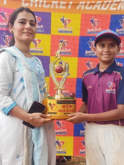 A player from the U-12 division receives the Man of the Series trophy, a prestigious award for the most impactful player in the tournament.