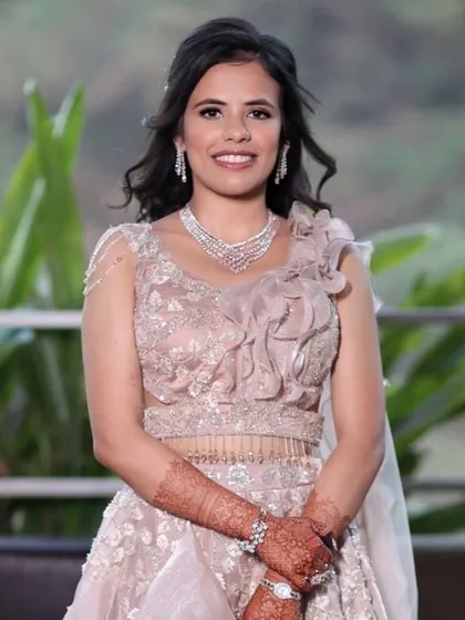 The full look for Rajvi's engagement. The pastel pink ruffled lehenga is so romantic, and her makeup is soft and dreamy to match.