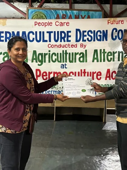 Here I am receiving my Permaculture Design certification. This training has deeply influenced my approach to gardening, emphasizing care for the earth, care for people, and sharing resources fairly.