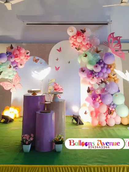 Another view of the butterfly garden party, showing the arrangement of the themed pedestals and props.