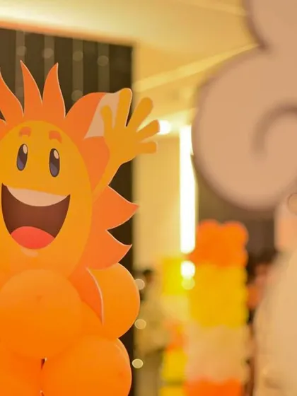 A cheerful, smiling sun character made from balloons adds a playful and friendly touch to the decor. These custom character props are always a hit with guests of all ages.