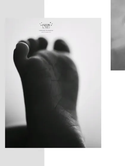 A macro shot of a newborn's foot in black and white. We focus on capturing every line and wrinkle in these detailed portraits.