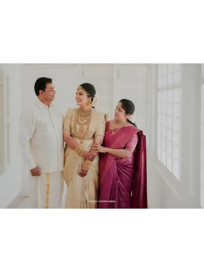 A lovely portrait of the bride with her parents, a cherished family moment from her wedding day.