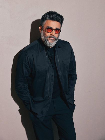 R. Madhavan styled in an all-black ensemble inspired by his character in 'Shaitaan', with red-tinted glasses adding a devilish touch.