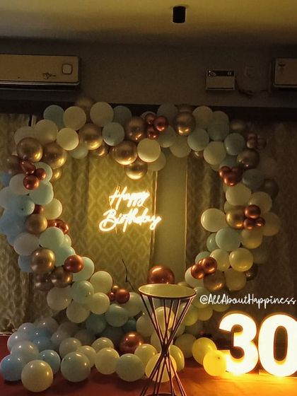 We are always creating new backdrops, like this stunning heart-shaped balloon arrangement in pastel blue, white, and gold for a 30th birthday.