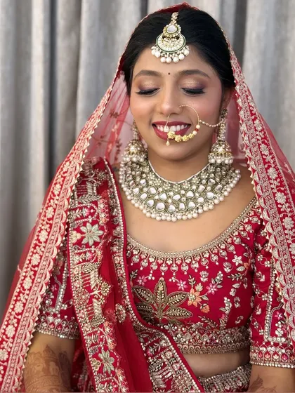 A close-up of the bride's smiling face, showing how the makeup enhances her features without looking heavy.