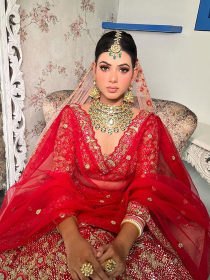 This look is all about timeless elegance. The gold and green jewelry pops beautifully against the red outfit.