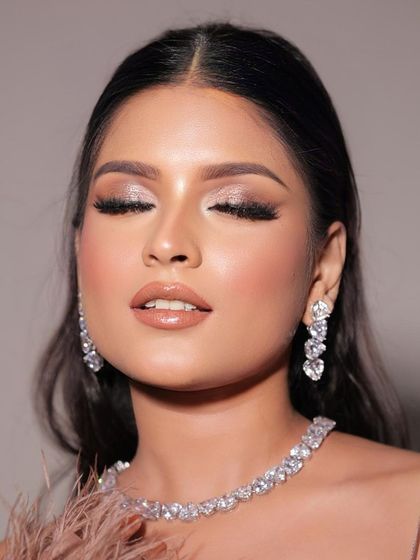 Serving glam vibes with this flawless makeup. This look features shimmery glitter eyes and a nude lip, perfect for any party.