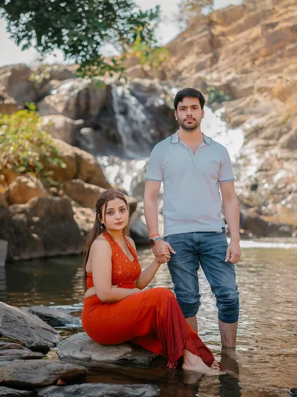 A stylish portrait of the couple by the water, showcasing their connection and the beauty of the natural location.