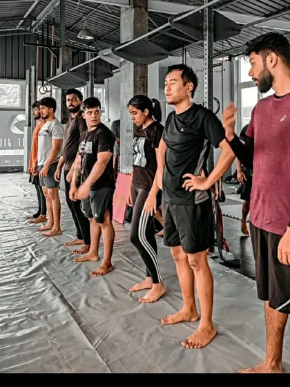 Our coaching team is built on three pillars: a clear curriculum, detailed instruction, and personal attention. Here, our instructors are leading a beginner's class, ensuring every student understands the fundamentals.
