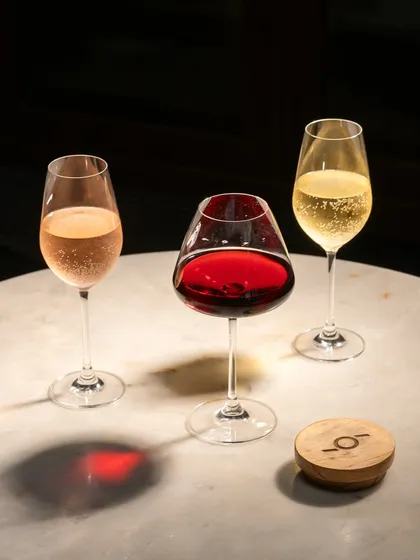 A flight of red, white, and rosé wine. This simple, elegant shot is perfect for a wine bar menu or a vineyard's promotional materials.