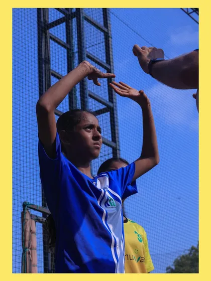 A young player learns the correct hand positioning for setting, with fingers spread to control the ball. I believe in teaching the details right from the start.