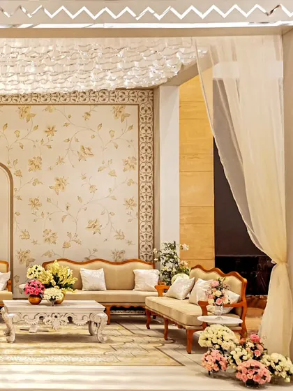A view of the lounge area through a sheer curtain, highlighting the layers and textures of the design. The mirrored frame adds a touch of glamour and reflects the light beautifully.
