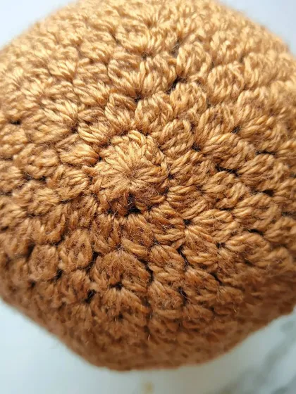 The crown of the Flora beanie, worked in a lovely tan DK yarn. Working in the round like this is a relaxing, meditative process.