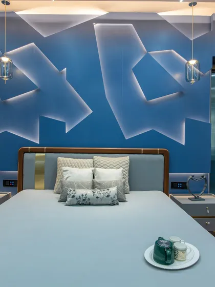 A bedroom can also be a canvas for bold expression. For this space, I created a custom 3D feature wall with integrated lighting. The geometric shapes and deep blue color create a dynamic yet restful atmosphere, showing that modern design can be both sculptural and serene.