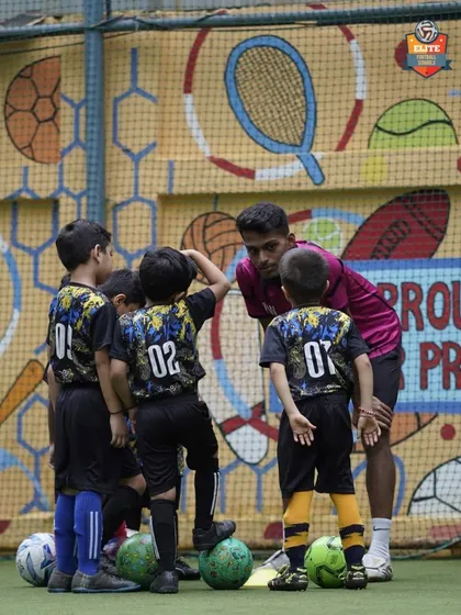 A coach huddles with our youngest players, giving them instructions in a way they can understand. Building trust and communication starts from day one.