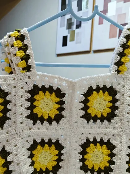 Another view of the sunflower top, showing the vibrant yellow and green against the white background. It truly feels like wearing a field of sunshine.