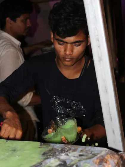 The action of pouring a fresh, cool drink for a guest. It's this kind of attentive service that defines the Rajdhani experience.
