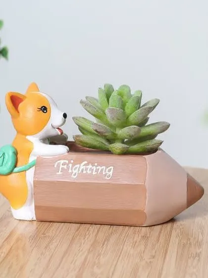 This corgi-themed planter is shaped like a pencil with the word "Fighting" on it. It's a motivational and cute desk accessory, perfect for holding a small succulent to cheer you on.
