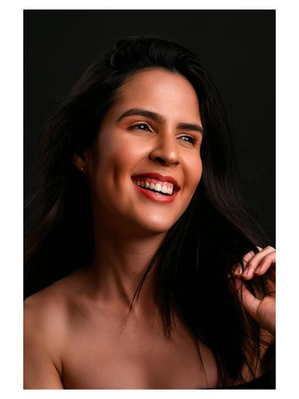 A joyful and radiant portrait. The model's bright smile is the centerpiece of this image, capturing a moment of pure happiness.