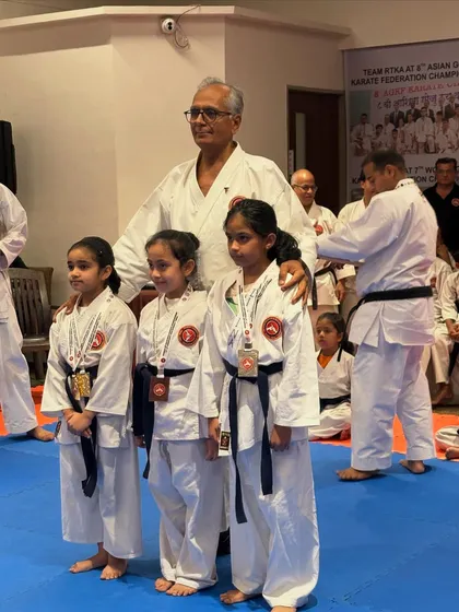 Three young champions with their Sensei. Our tournaments provide a platform for students to shine, and we celebrate every achievement, big or small.