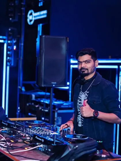 Giving a thumbs up from the DJ booth at White Lotus Club. It's all about connecting with the crowd and ensuring everyone is having a great time.
