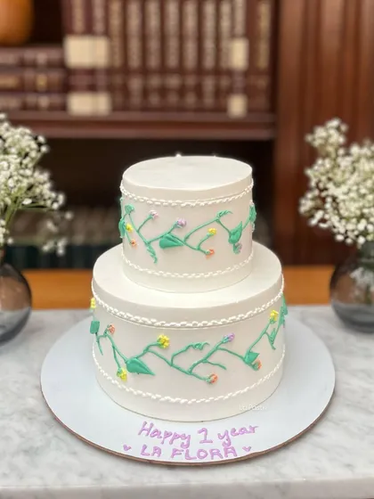 This minimal two-tier cake was created to celebrate a first anniversary, as noted by the sweet handwritten message.