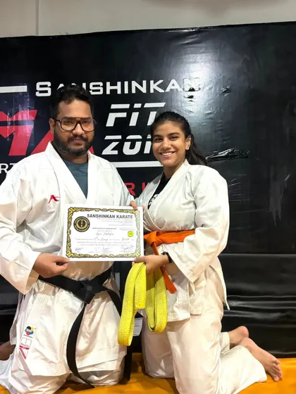 The karate belt test is a significant milestone in a martial artist's journey. Here, a student is awarded her new belt and certificate, marking her progress and dedication to the art.