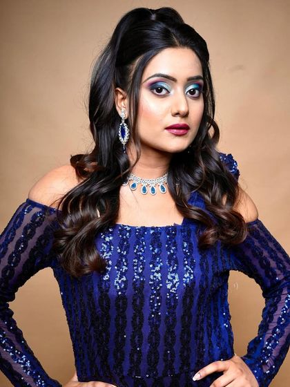 The half-up hairstyle complements the dramatic makeup. You will learn how to balance hair and makeup for a complete look.