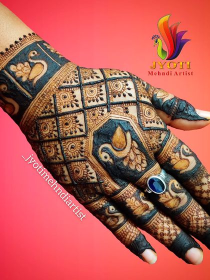 A stunning back-of-hand design perfect for Karwa Chauth or a wedding. The pattern uses negative space and dark fills to create a bold look with multiple peacock figures.