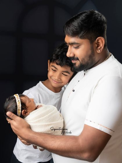 A father and son share a special moment with the family's newest addition. We capture the love that surrounds a newborn from every member of the family.