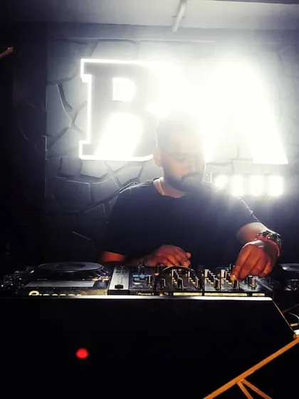 A focused moment at the DJ booth at RM Club. The right lighting and a powerful sound system are key to creating an immersive musical experience.