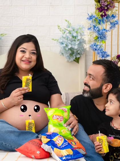 Sometimes, the most memorable shots are the most playful. This fun-filled maternity session captures the family's personality with their favorite snacks and a cute drawing on the baby bump.