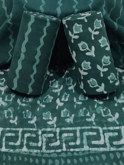 This teal block print suit fabric has a unique geometric border, perfect for creating a contemporary ethnic outfit.