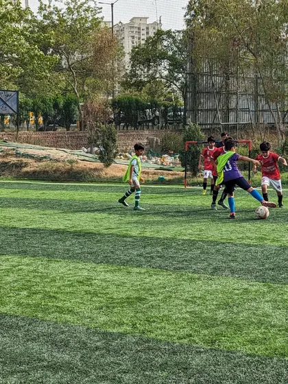 A moment of quick thinking as a player controls the ball under pressure from the opposition.