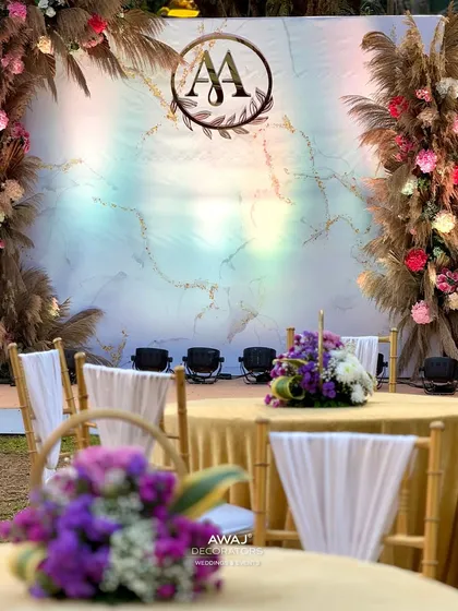 A view of the boho-chic stage from a guest's table, showing the beautiful floral centerpieces in the foreground.