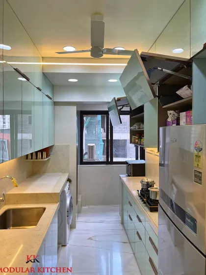 This shot shows the bi-fold lift-up cabinets in action, providing easy access to stored items without obstructing the workspace.