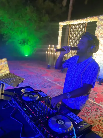 On the mic at a private celebration. I don't just play music; I interact with the crowd to keep the party alive and ensure everyone is having a good time.