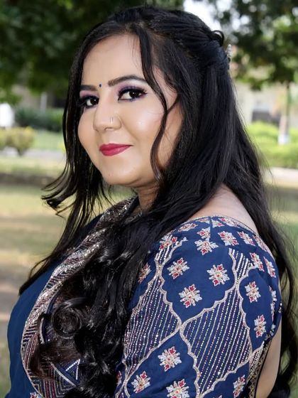 A side profile that captures the soft hairstyle and the beautiful smile of the bride-to-be.