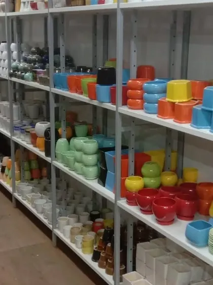 Another view of our ceramic pot aisle, showing the depth of our collection. We stock everything from small succulent pots to larger indoor planters.