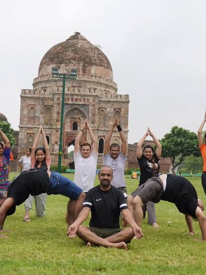 A creative group yoga pose in the park. Our yogic picnic is a perfect blend of practice and play.