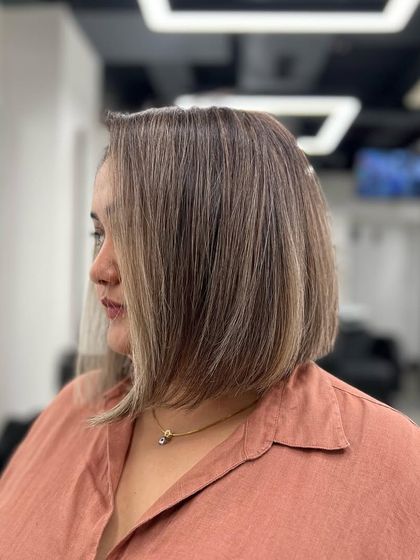 Have a good hair day. This client is showing off her new bob with subtle highlights, a classic and sophisticated look.