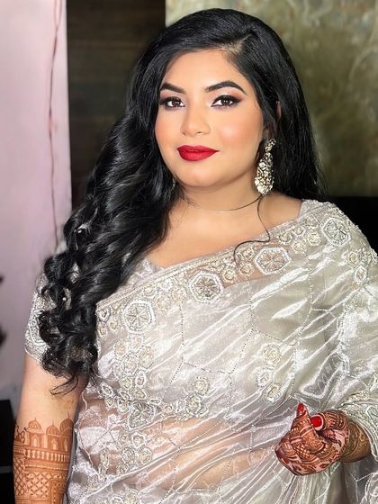 A classic pose showing off the bold red lip and glamorous waves. This look is perfect for a reception or cocktail party.