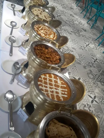 The elegance is in the details. Our classic North Indian buffet line features a series of ornate brass and copper serving dishes, keeping the food warm and adding a touch of regal sophistication to your event's dining setup.