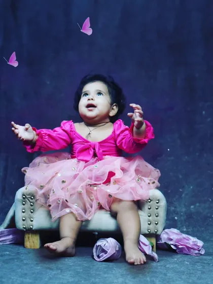 A magical toddler portrait with a simple setup. The upward gaze and the edited butterflies create a sense of wonder and innocence.