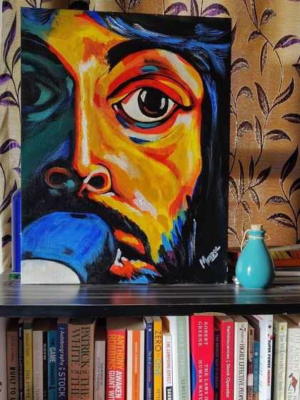 My abstract acrylic portrait displayed on a bookshelf. I love seeing how my art fits into people's living spaces and becomes part of their daily lives.