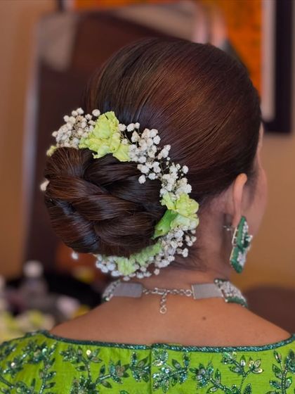 The intricate details of a floral bun, combining different textures of flowers.