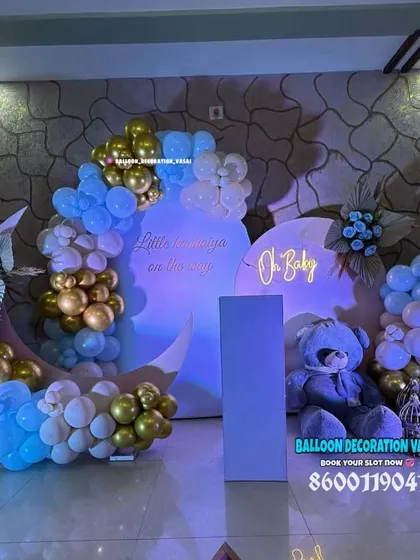 A dreamy "Oh Baby" theme featuring a large teddy bear, moon-shaped backdrops, and a soft color palette of blue, white, and gold. The ambient lighting gives the entire setup a gentle, serene glow.