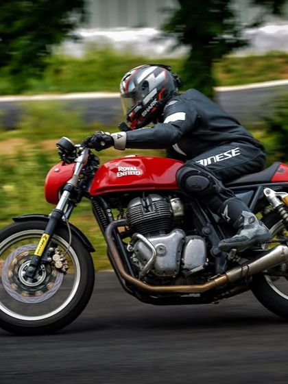 A rider on a Royal Enfield GT 650 during a training session, demonstrating a relaxed and controlled posture.